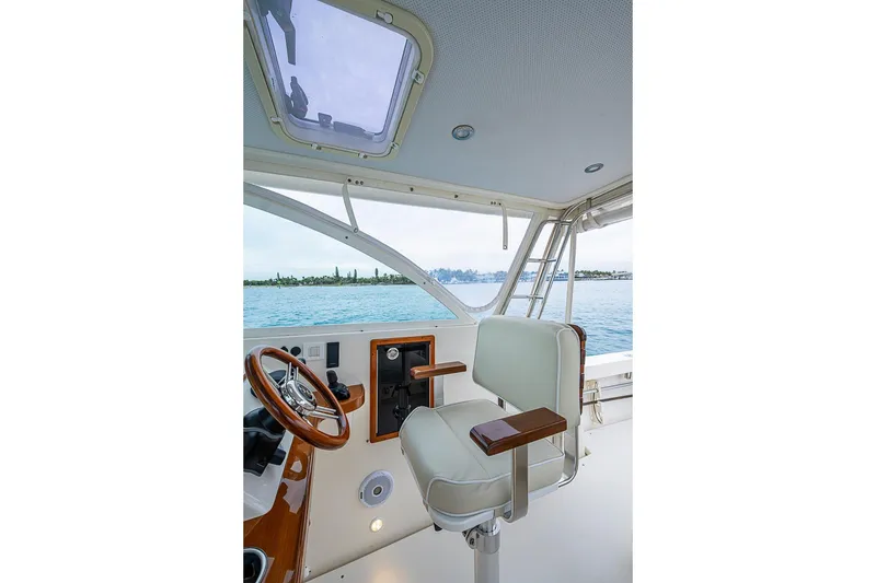 Slide: The Image of 2019 Hunt Yachts Surfhunter 32 helm with leather seat and wooden steering wheel. - 27