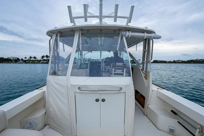 Slide: The Image of 2019 Hunt Yachts Surfhunter 32 on calm waters, showcasing cockpit and helm area. - 34