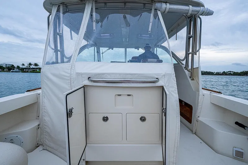 Slide: The Image of 2019 Hunt Yachts Surfhunter 32 cockpit with enclosed helm, on calm waters. - 35