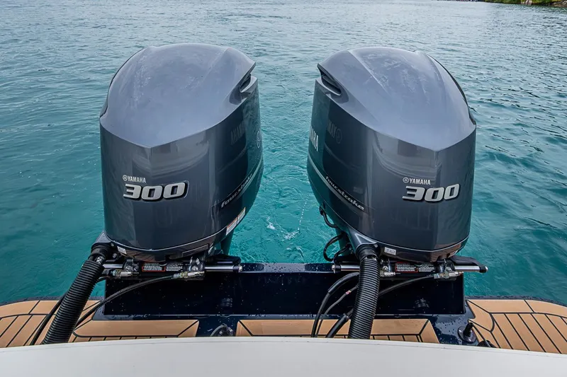 Slide: The Image of Twin Yamaha 300 engines on 2019 Hunt Yachts Surfhunter 32 in clear blue water. - 37
