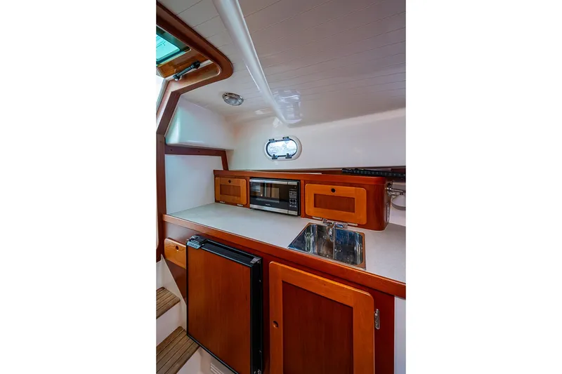Slide: The Image of 2019 Hunt Yachts Surfhunter 32 galley with wood cabinetry, sink, microwave, and compact fridge. - 40