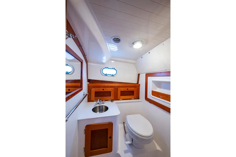 Slide: The Image of 2019 Hunt Yachts Surfhunter 32 bathroom with sink, toilet, and wooden cabinetry. - 41