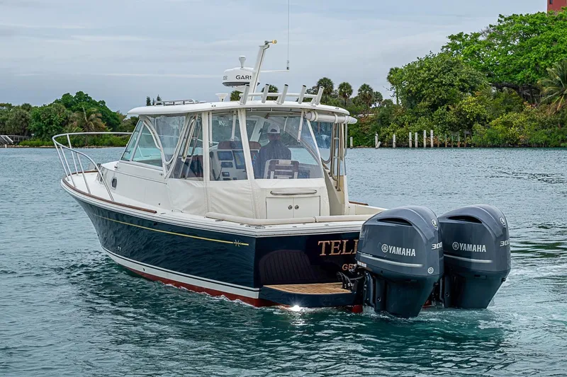 Slide: The Image of 2019 Hunt Yachts Surfhunter 32 with twin Yamaha engines cruising on a serene waterway. - 5