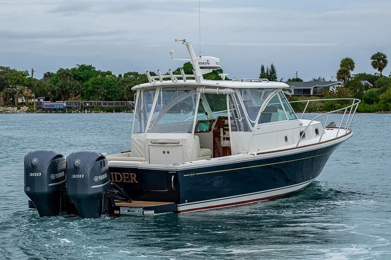 Slide: The Image of 2019 Hunt Yachts Surfhunter 32 cruising on a calm waterway with twin Yamaha engines. - 8