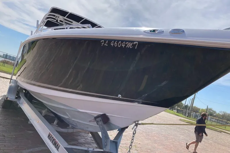 Slide: The Image of 2005 Donzi 35 ZF Daytona boat on trailer, parked outdoors under clear sky. - 9