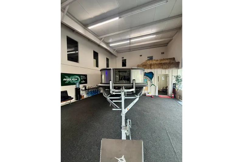 Slide: The Image of Indoor display of 2026 Alera A 22 Q boat on trailer in showroom. - 4