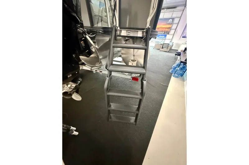 Slide: The Image of Ladder on Alera A 22 Q boat, 2026 model, in showroom setting. - 6