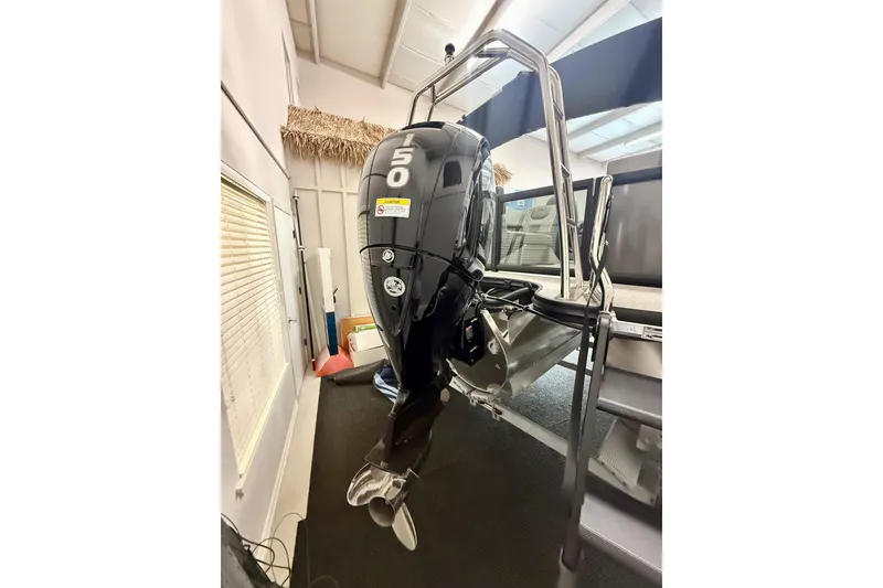 Slide: The Image of Outboard motor on Alera A 22 Q boat, 2026 model, in showroom setting. - 7