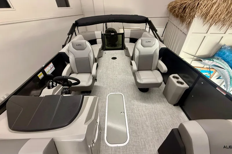 Slide: The Image of 2026 Alera A 22 Q boat interior with modern seating and steering console. - 9