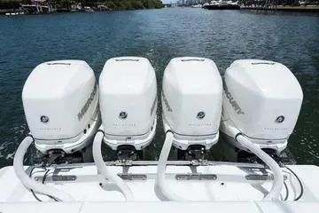 Slide: The Image of Four Mercury outboard engines on a 2017 SeaVee 390Z boat, docked on a calm waterway. - 10