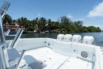 Slide: The Image of 2017 SeaVee 390Z boat with multiple engines, docked near tropical shoreline. - 11