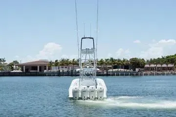 Slide: The Image of 2017 SeaVee 390Z boat cruising on a sunny day near waterfront homes. - 12