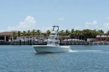 Slide: The Image of 2017 SeaVee 390Z boat cruising on a sunny day near waterfront homes. - 2