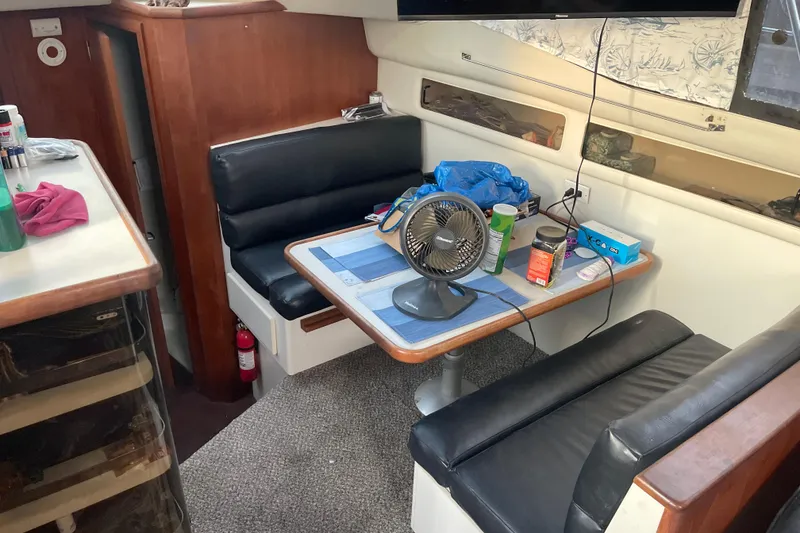 Slide: The Image of Interior of 1995 Carver 350 Aft Cabin Motor Yacht with dining area and fan. - 10