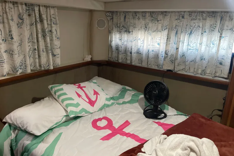 Slide: The Image of Cozy cabin interior of 1995 Carver 350 Aft Cabin Motor Yacht with nautical-themed bedding. - 12