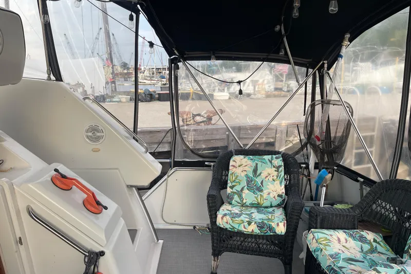 Slide: The Image of 1995 Carver 350 Aft Cabin Motor Yacht interior with floral cushioned seating. - 14