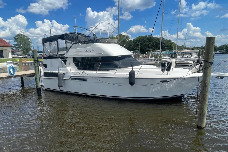 Slide: The Image of 1995 Carver 350 Aft Cabin Motor Yacht docked at marina under blue sky. - 16