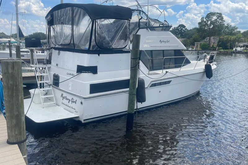 Slide: The Image of 1995 Carver 350 Aft Cabin Motor Yacht docked at marina, sunny day. - 2