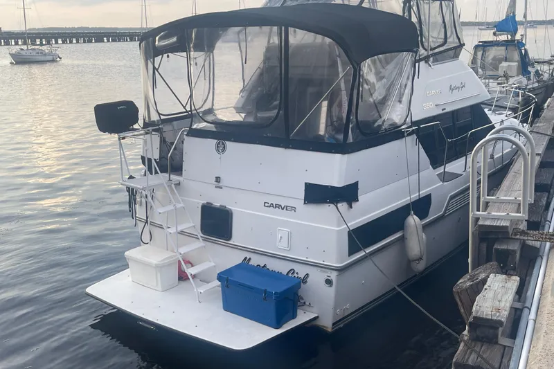 Slide: The Image of 1995 Carver 350 Aft Cabin Motor Yacht docked at marina, rear view. - 3