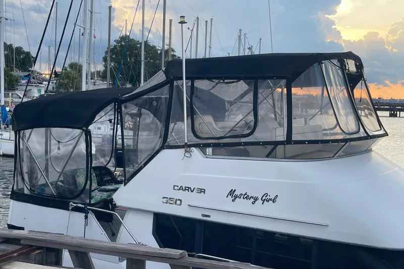 Slide: The Image of 1995 Carver 350 Aft Cabin Motor Yacht docked at sunset, named "Mystery Girl." - 5