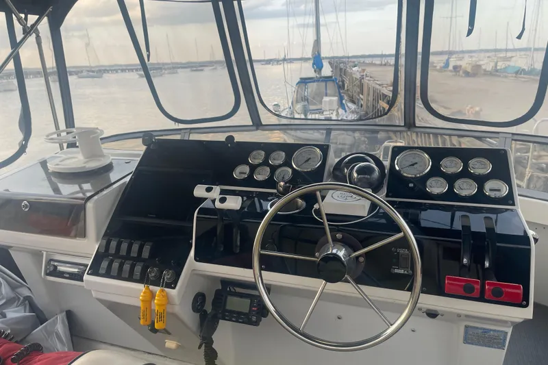 Slide: The Image of 1995 Carver 350 Aft Cabin Motor Yacht helm with gauges and steering wheel. - 7