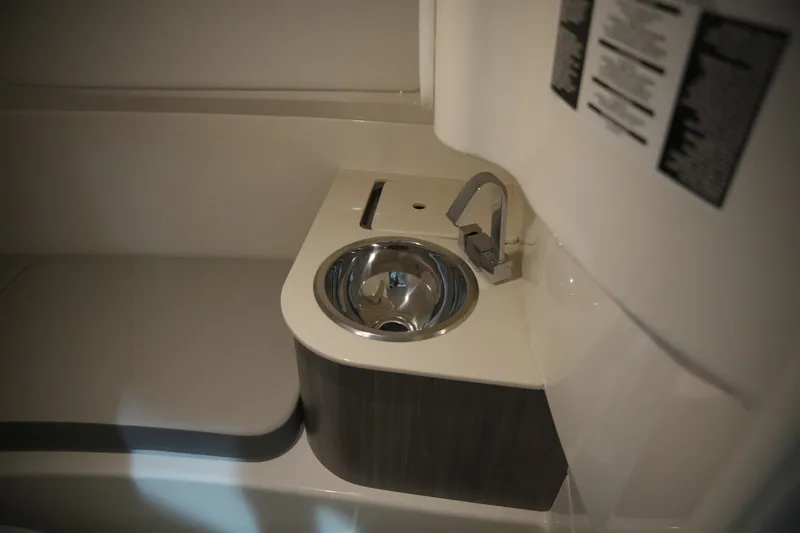 Slide: The Image of The image shows a modern sink in a boat bathroom with a sleek faucet. - 31