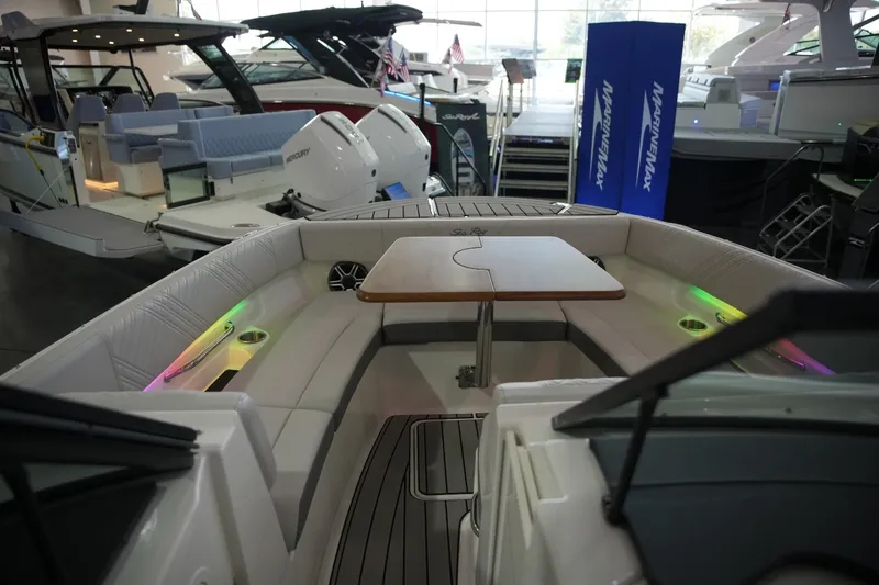 Slide: The Image of The image shows the cockpit of a 2026 Sea Ray SDX 270 with a table and seating. - 34