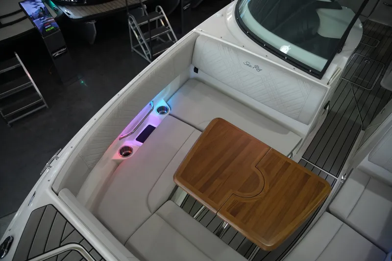 Slide: The Image of The image shows the cockpit of a 2026 Sea Ray SDX 270 with sleek white seating and a wooden table. - 35