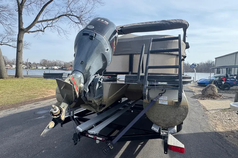 Slide: The Image of 2020 Bennington 22SSRXP pontoon boat with outboard motor on trailer by a lakeside. - 10