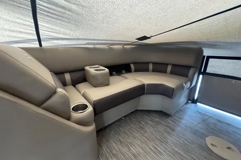 Slide: The Image of Luxurious seating area in a 2020 Bennington 22SSRXP pontoon boat with cup holders. - 12