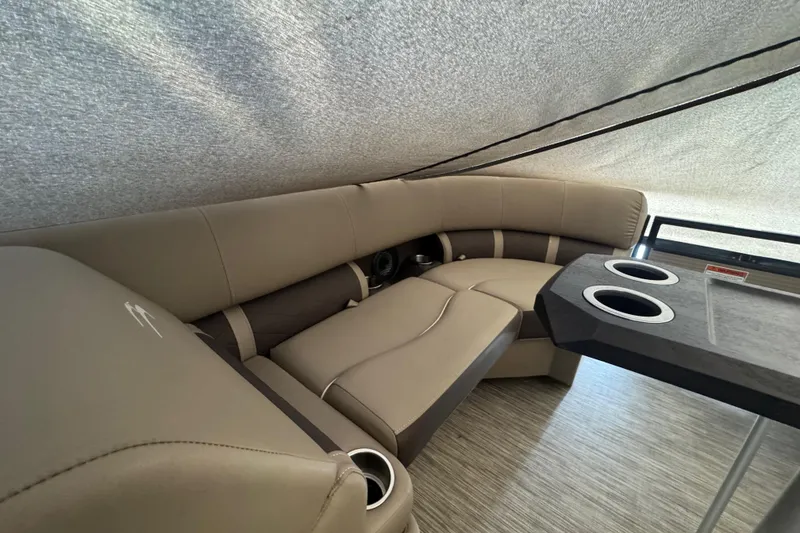 Slide: The Image of Interior of a 2020 Bennington 22SSRXP pontoon boat with beige seating and table. - 20