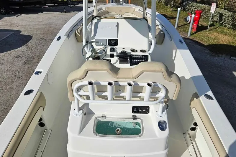 Slide: The Image of 2018 NauticStar 25 XS boat interior with steering console and rod holders. - 5