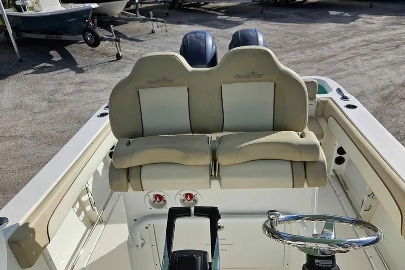 Slide: The Image of 2018 NauticStar 25 XS boat interior with dual seats and steering wheel. - 8