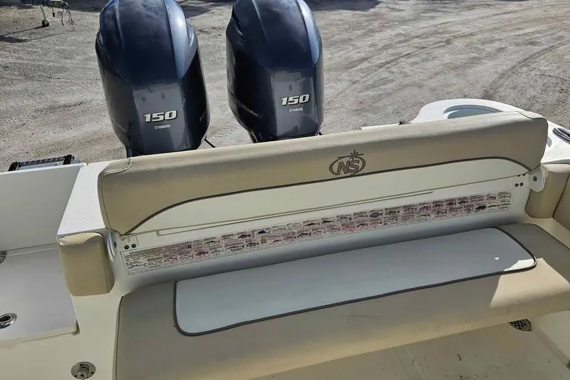 Slide: The Image of 2018 NauticStar 25 XS boat with twin Yamaha 150 engines, rear seating view. - 9