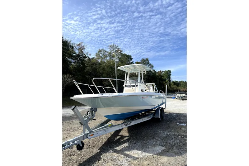 Slide: The Image of 2018 Boston Whaler 240 Dauntless boat on trailer under a clear sky. - 3