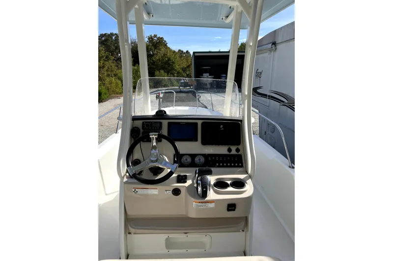 Slide: The Image of 2018 Boston Whaler 240 Dauntless boat console with steering wheel and navigation controls. - 4