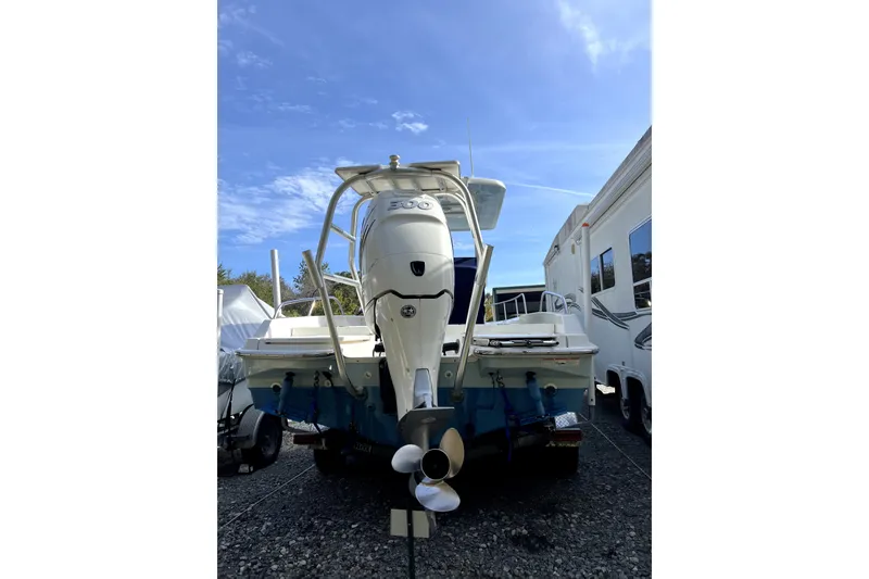 Slide: The Image of 2018 Boston Whaler 240 Dauntless boat with powerful outboard motor, parked outdoors. - 6