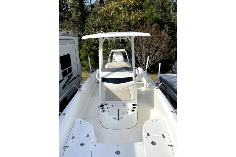 Slide: The Image of 2018 Boston Whaler 240 Dauntless boat with T-top, parked outdoors. - 9