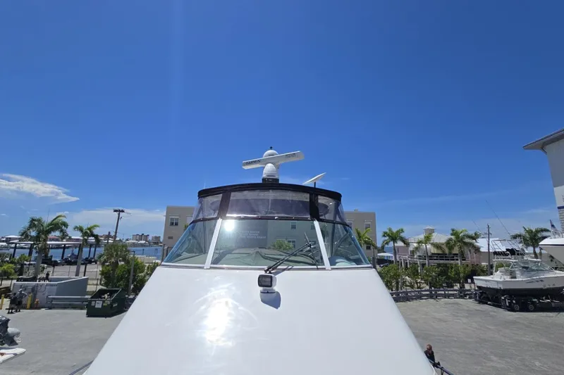 Slide: The Image of 2007 Cruisers Yachts 447 Sport Sedan docked under clear blue sky. - 12