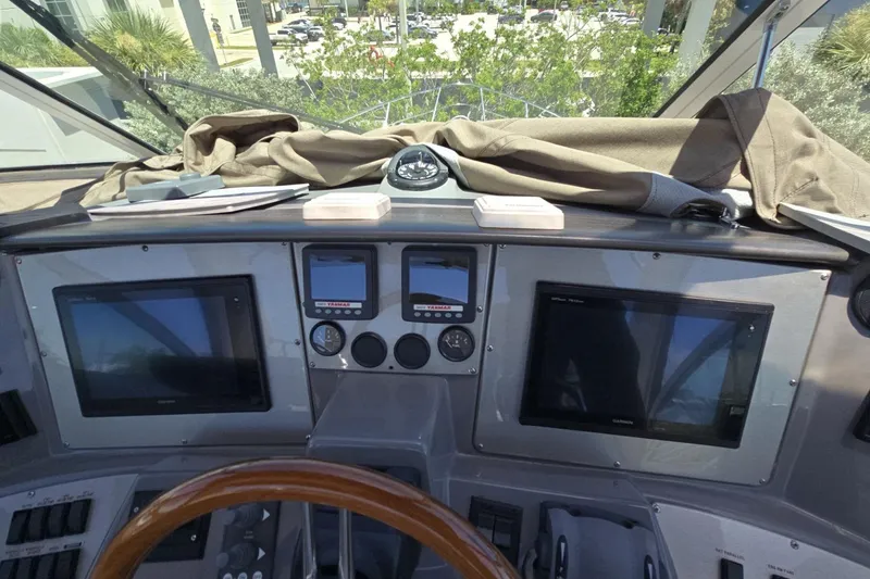 Slide: The Image of 2007 Cruisers Yachts 447 Sport Sedan helm with navigation screens and compass. - 16