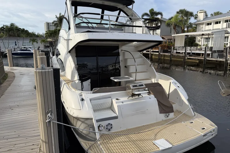 Slide: The Image of 2007 Cruisers Yachts 447 Sport Sedan docked at marina with modern amenities. - 26