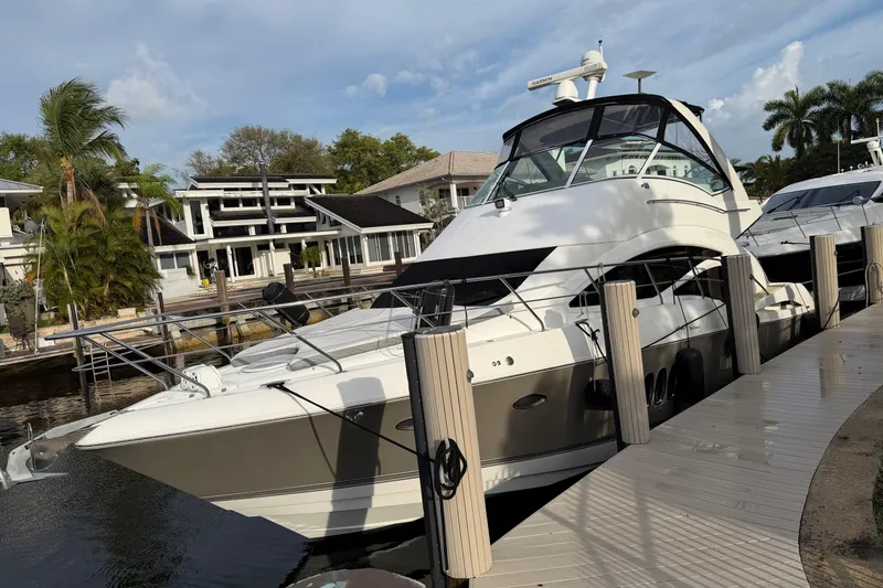 Slide: The Image of 2007 Cruisers Yachts 447 Sport Sedan docked near waterfront homes. - 28