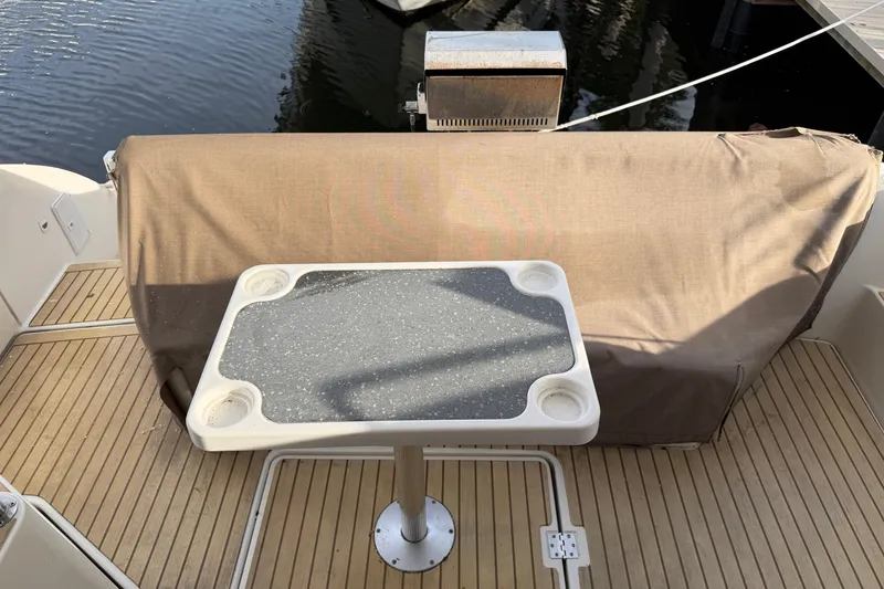 Slide: The Image of 2007 Cruisers Yachts 447 Sport Sedan deck with table and covered grill. - 29