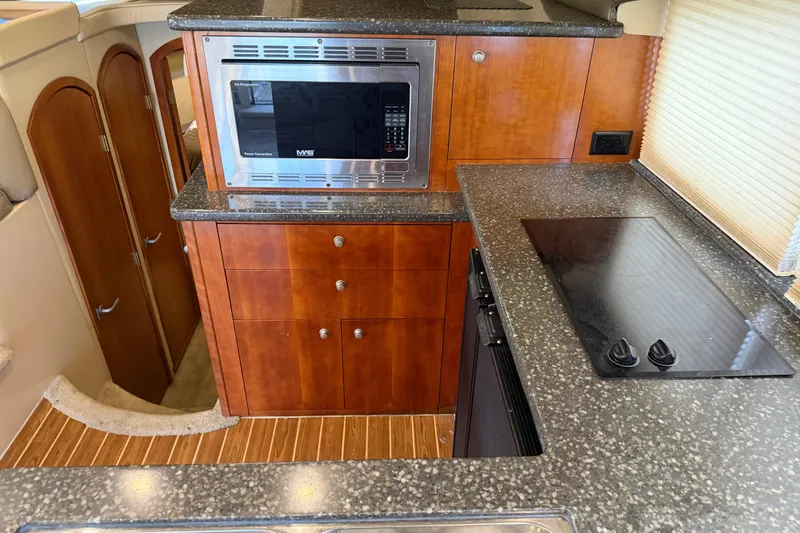 Slide: The Image of 2007 Cruisers Yachts 447 Sport Sedan kitchen with microwave and stovetop. - 34