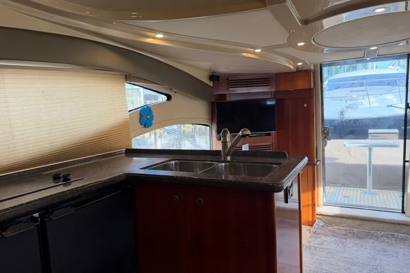 Slide: The Image of Interior of 2007 Cruisers Yachts 447 Sport Sedan with modern kitchen and outdoor view. - 36