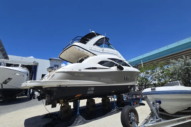 Slide: The Image of 2007 Cruisers Yachts 447 Sport Sedan on dry dock under clear blue sky. - 4
