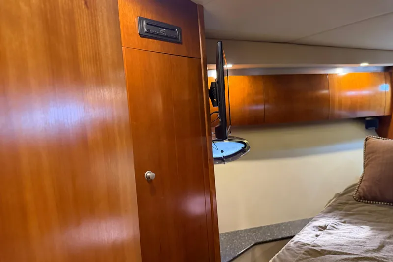Slide: The Image of Interior of 2007 Cruisers Yachts 447 Sport Sedan with wood paneling and mounted TV. - 41