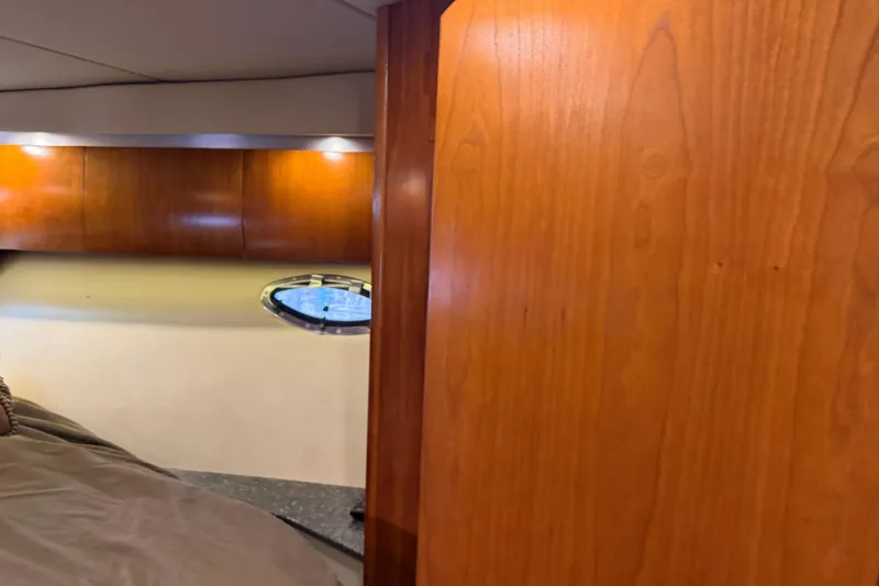 Slide: The Image of 2007 Cruisers Yachts 447 Sport Sedan interior with wood paneling and porthole window. - 42