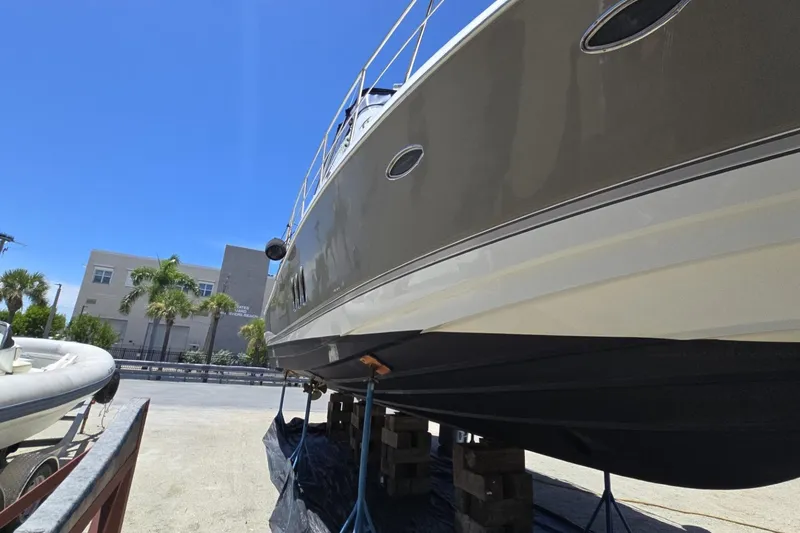 Slide: The Image of 2007 Cruisers Yachts 447 Sport Sedan on dry dock under clear blue sky. - 5