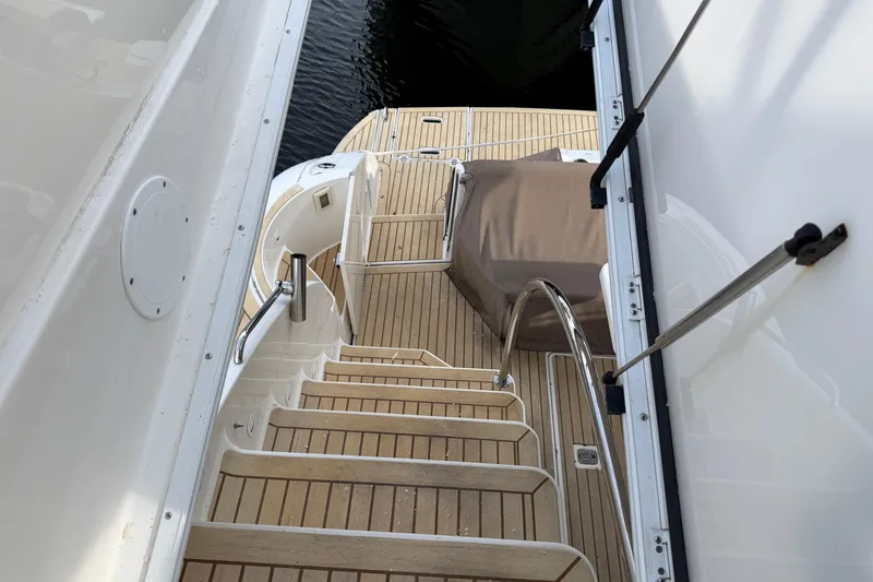 Slide: The Image of Staircase on 2007 Cruisers Yachts 447 Sport Sedan with teak decking and stainless steel railings. - 54